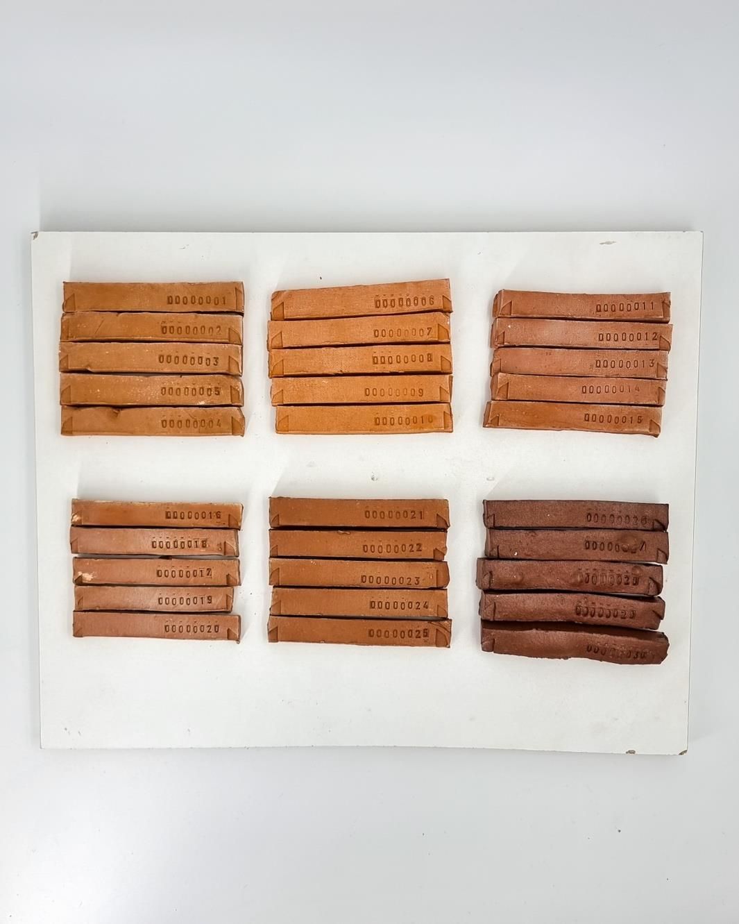 Fired test bars of Park Royal clay, each stamped with its batch number.